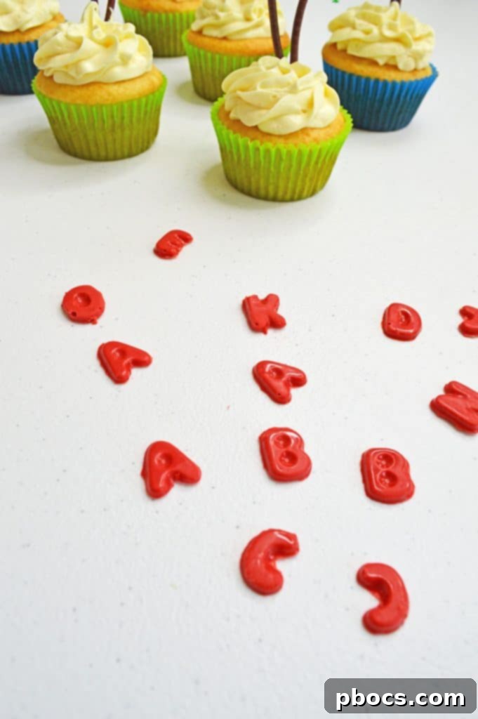 Chicka Boom Alphabet Treats 12 A close-up shot of a Chicka Chicka Boom Boom cupcake with a prominent palm tree and scattered candy letters.