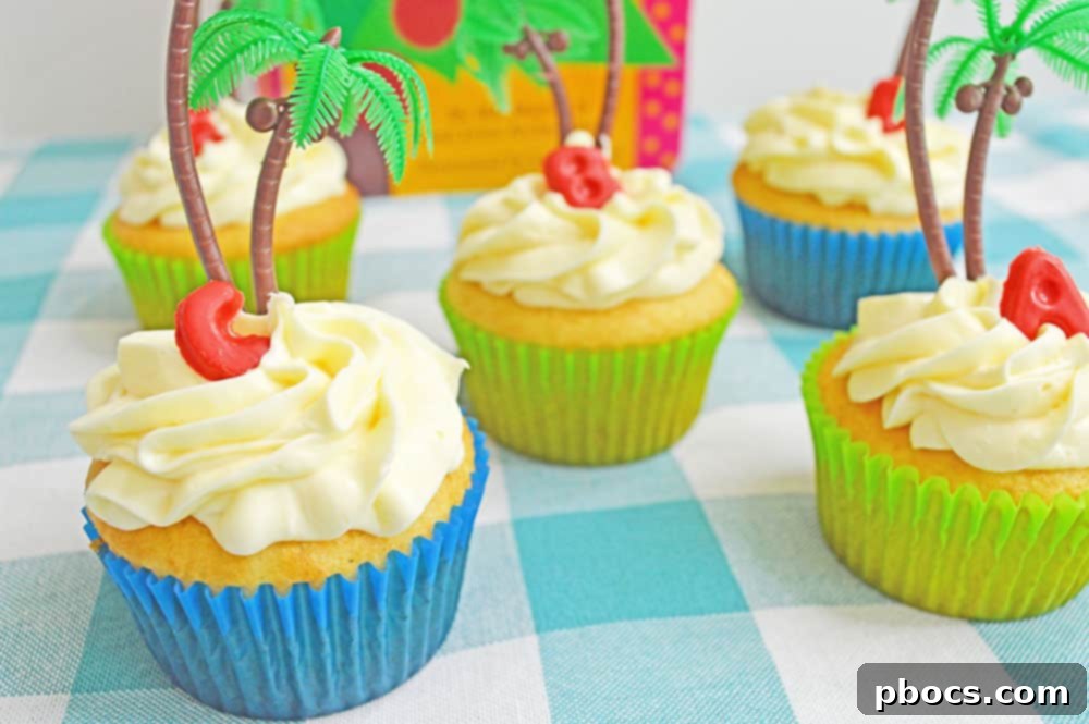 Chicka Boom Alphabet Treats 14 A beautifully decorated Chicka Chicka Boom Boom cupcake, complete with a palm tree and vibrant alphabet candy letters, presented for enjoyment.