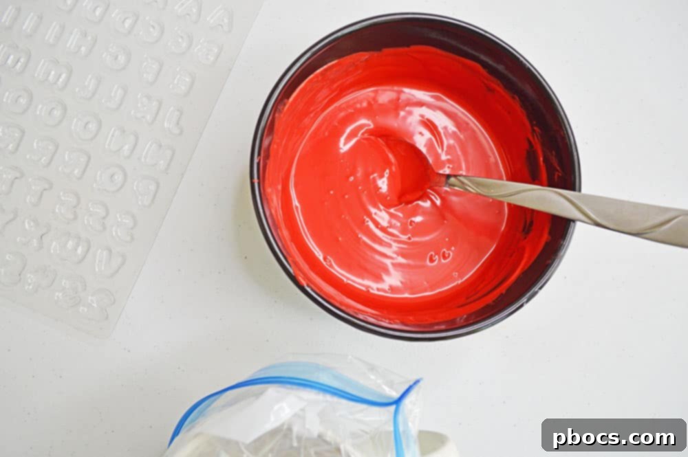 Chicka Boom Alphabet Treats 6 Colored candy melts in small bowls, some partially melted, ready for stirring.