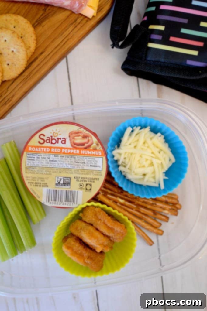A selection of DIY lunchable items, including pita bread, hummus, cheese, and vegetables.