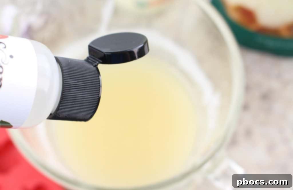 Craft Your Own Apple Lotion Bars 5 Adding apple soap fragrance oil to the warm, melted mixture of shea butter, coconut oil, and beeswax.