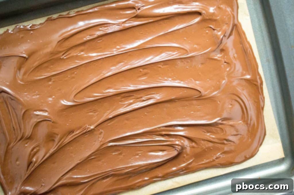 Melting chocolate chips in a microwave-safe bowl for Halloween candy bark