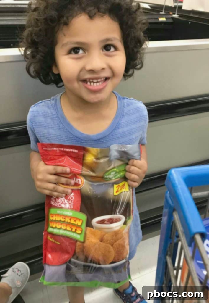 Another perspective of the spooky chicken nugget spider bites on a rustic serving board.