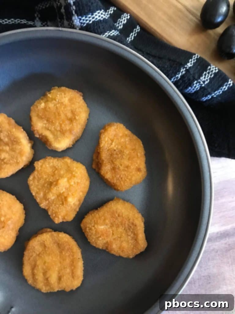Tyson Chicken Nuggets arranged on a baking sheet, ready for toppings.