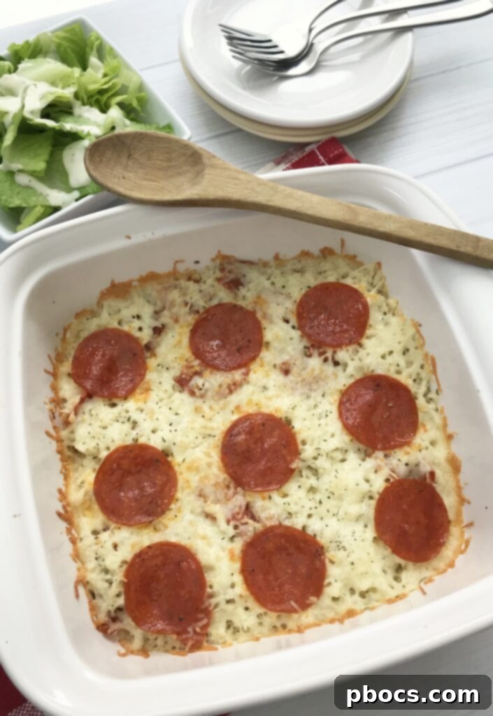 Keto Pizza Casserole, a delightful low-carb alternative to traditional pizza, featuring melted cheese and pepperoni on a bed of cauliflower