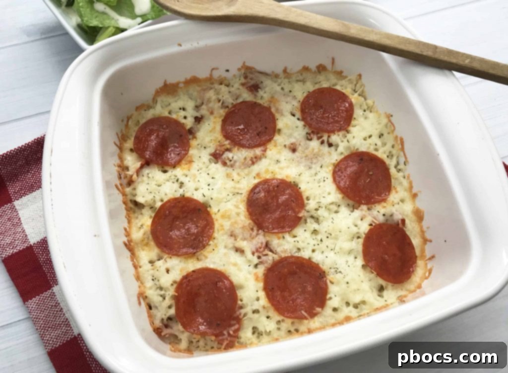 Close-up of baked Keto Pizza Casserole, showcasing vibrant pepperoni and bubbling mozzarella cheese