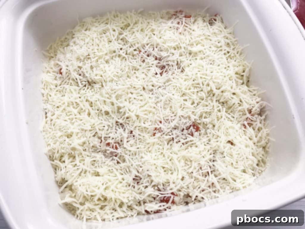 Mixing the riced cauliflower, mozzarella cheese, Italian seasoning, and quartered pepperoni for a delicious low-carb pizza base