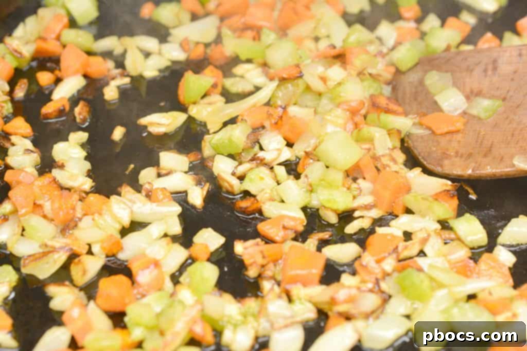 Browning ground beef with sautéed vegetables