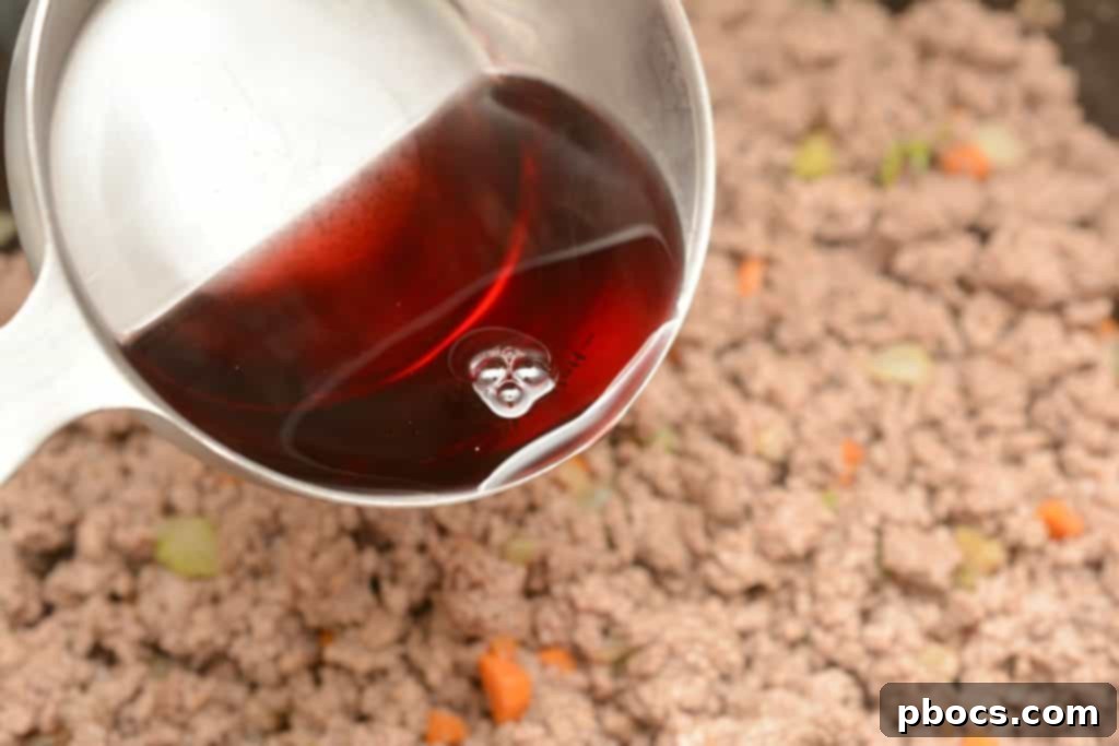 Deglazing the pot with red cooking wine
