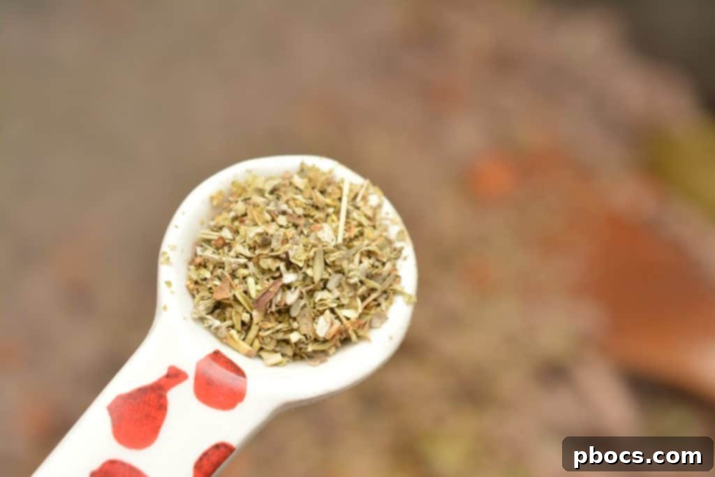 Adding Italian seasoning, basil, bay leaves, salt, and pepper to the meat mixture