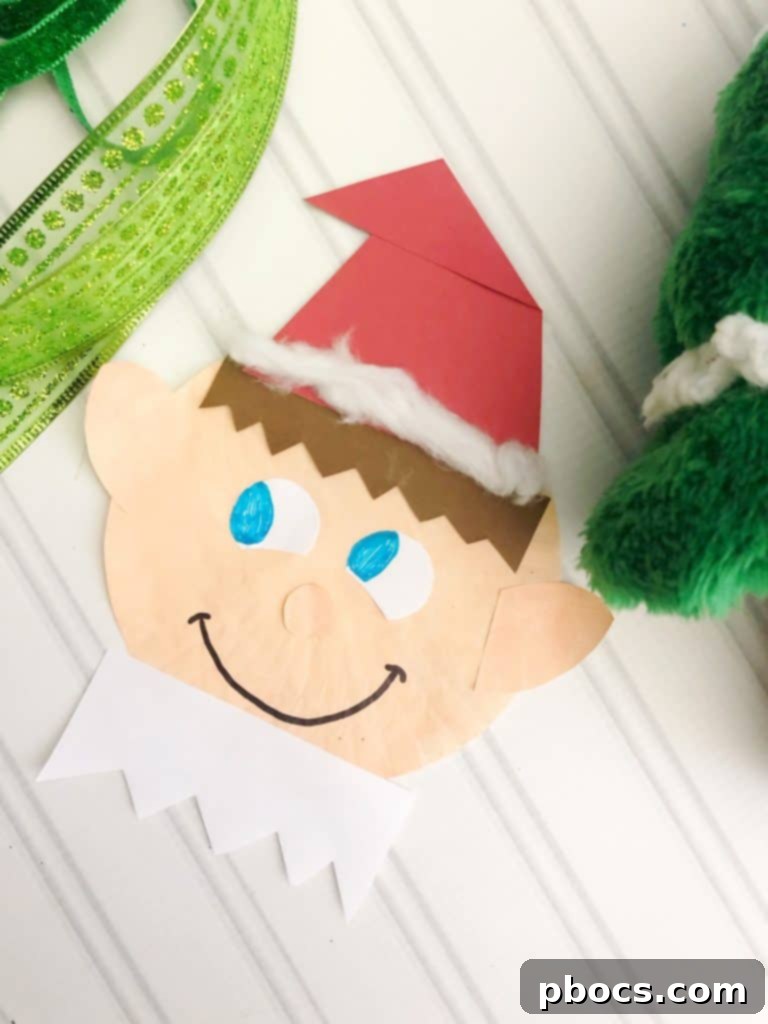 The white zigzag collar glued to the bottom of the elf's face, completing the craft.