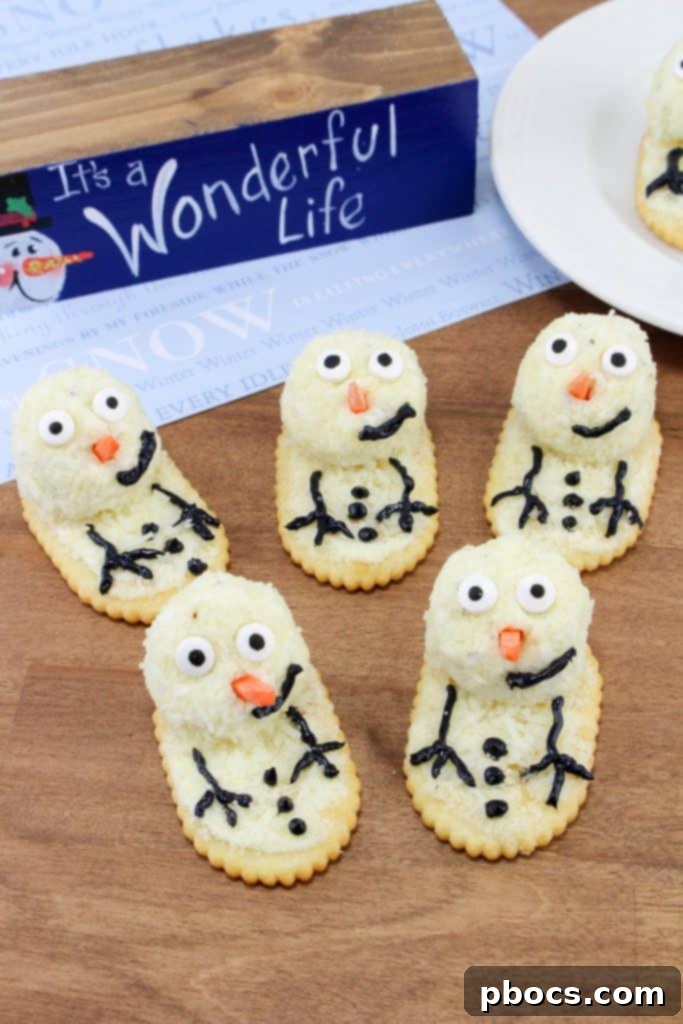 Frosty's Farewell Cheeseball 4 Melting Snowman Cheeseball served on a platter with crackers, ready for a holiday party.