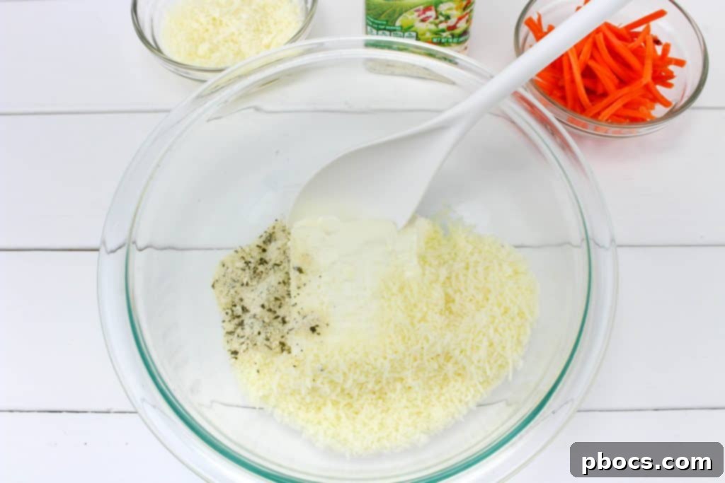 Frosty's Farewell Cheeseball 5 Mixing cream cheese, mozzarella, and ranch seasoning for the snowman cheeseball base.