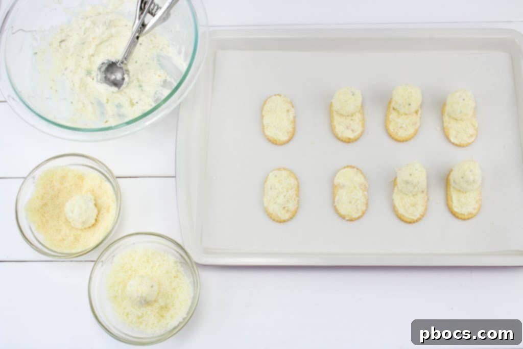 Frosty's Farewell Cheeseball 7 Rolling cheese mixture into balls and coating with parmesan cheese before placing on crackers.