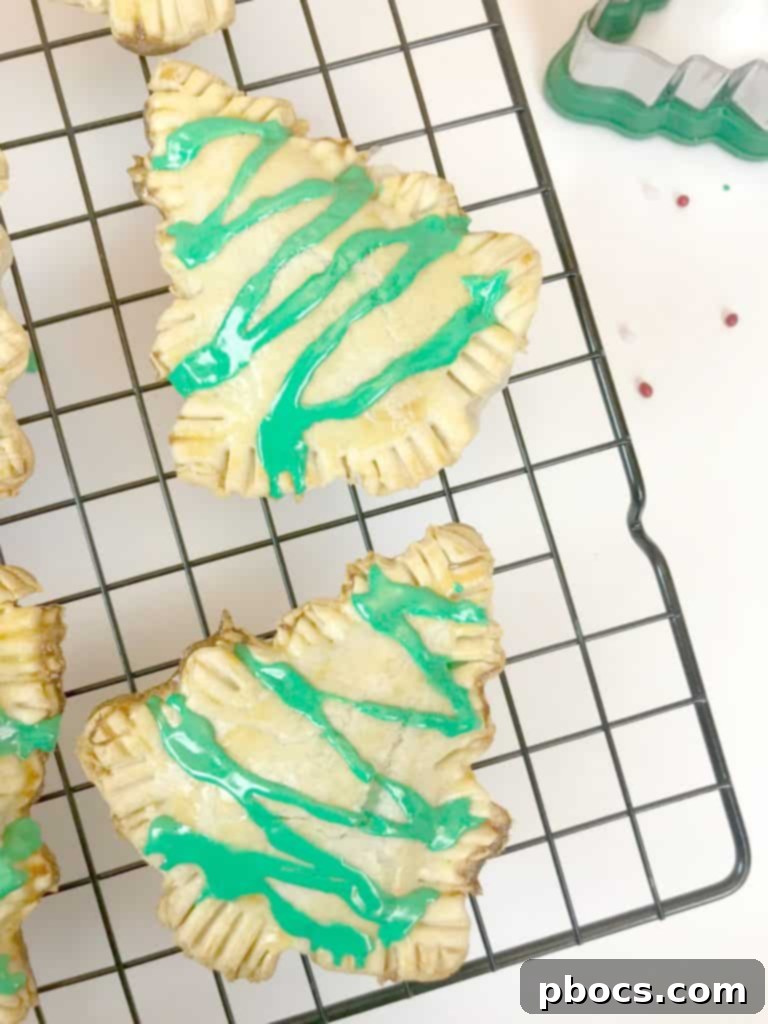 No-Fuss Festive Tree Treats 12 Baked golden-brown Christmas tree pastries fresh from the oven.
