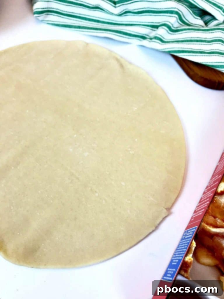 No-Fuss Festive Tree Treats 7 Unrolling premade pie crusts on a floured surface.