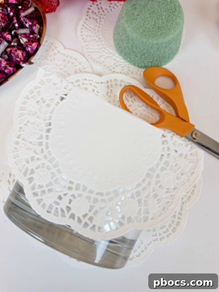 Homemade Valentine's Treat Dish 6 Measuring and cutting doily paper to fit the rim of a glass vase for a DIY Valentine's Day candy dish.