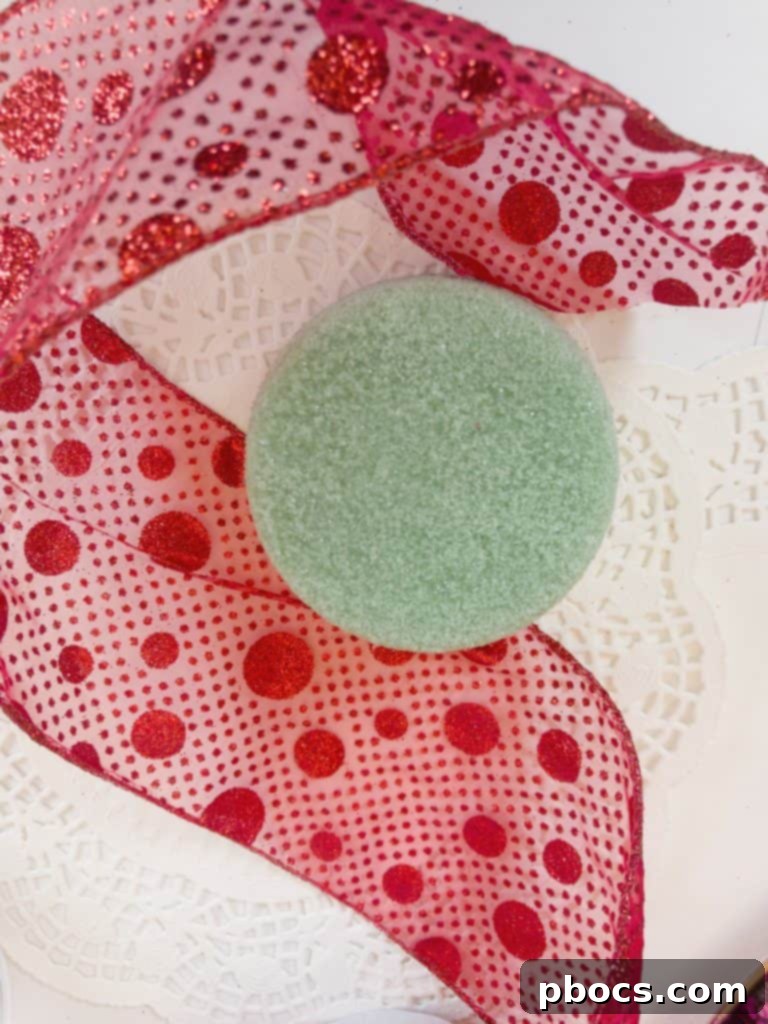 Homemade Valentine's Treat Dish 8 Wrapping a circular foam piece with red fabric to create a soft base for decorative elements in the candy dish.