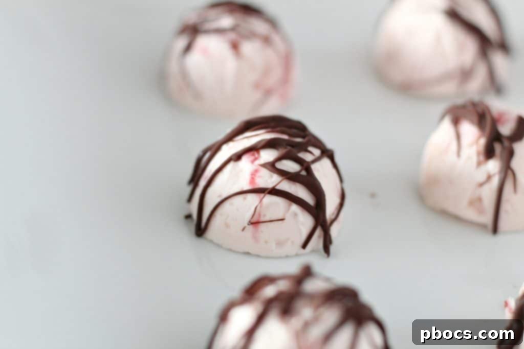 Keto Strawberry Cheesecake Fat Bombs with chocolate drizzle