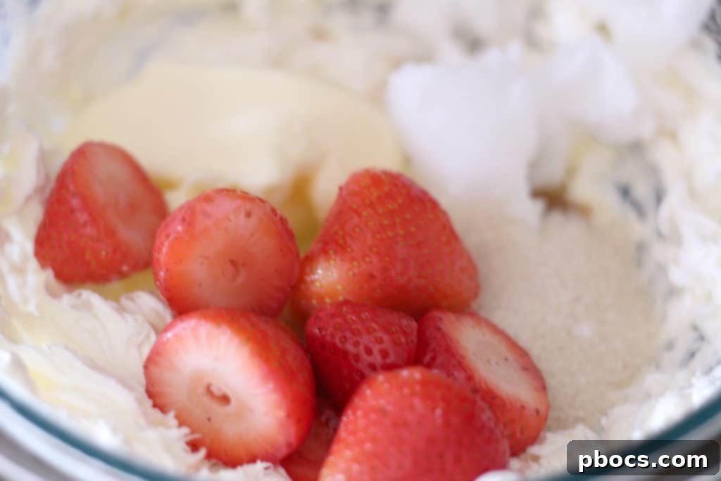 Beating cream cheese for Keto Strawberry Cheesecake Fat Bombs