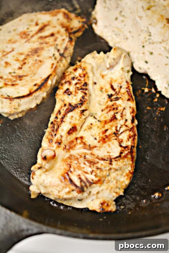 Marinating chicken covered in a bowl in the refrigerator for optimal flavor infusion.