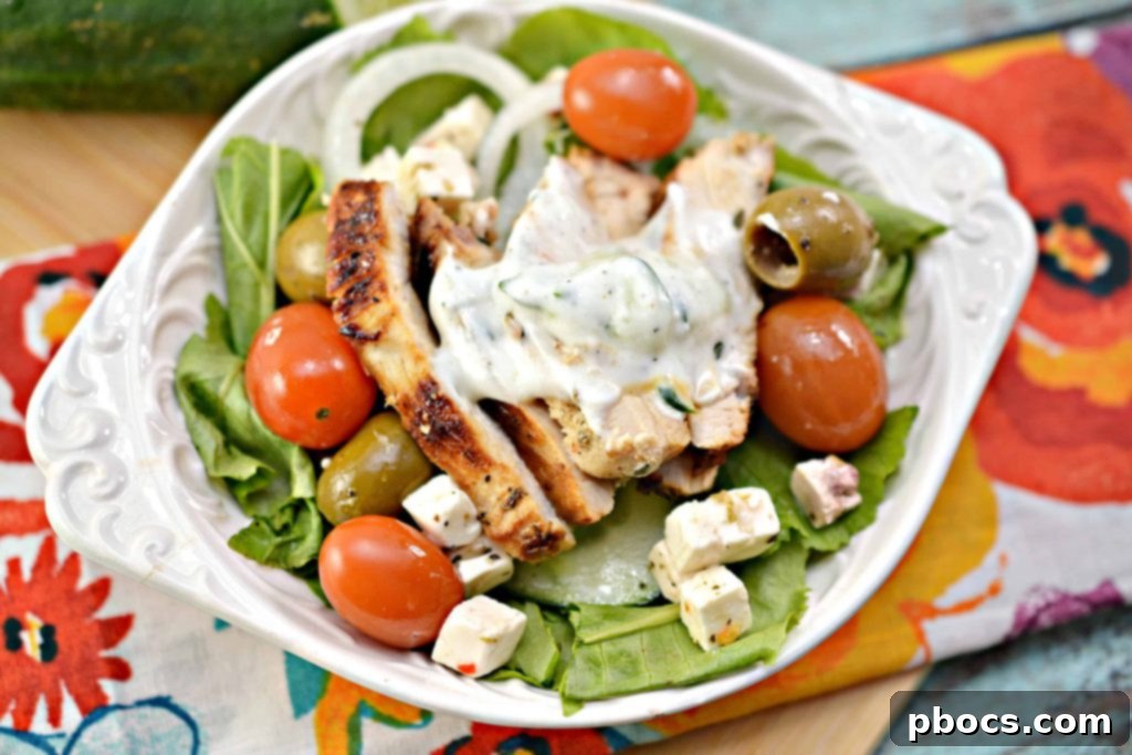 A close-up view of a freshly prepared Low Carb Greek Chicken Bowl, garnished with Tzatziki sauce, showcasing the texture and appeal.