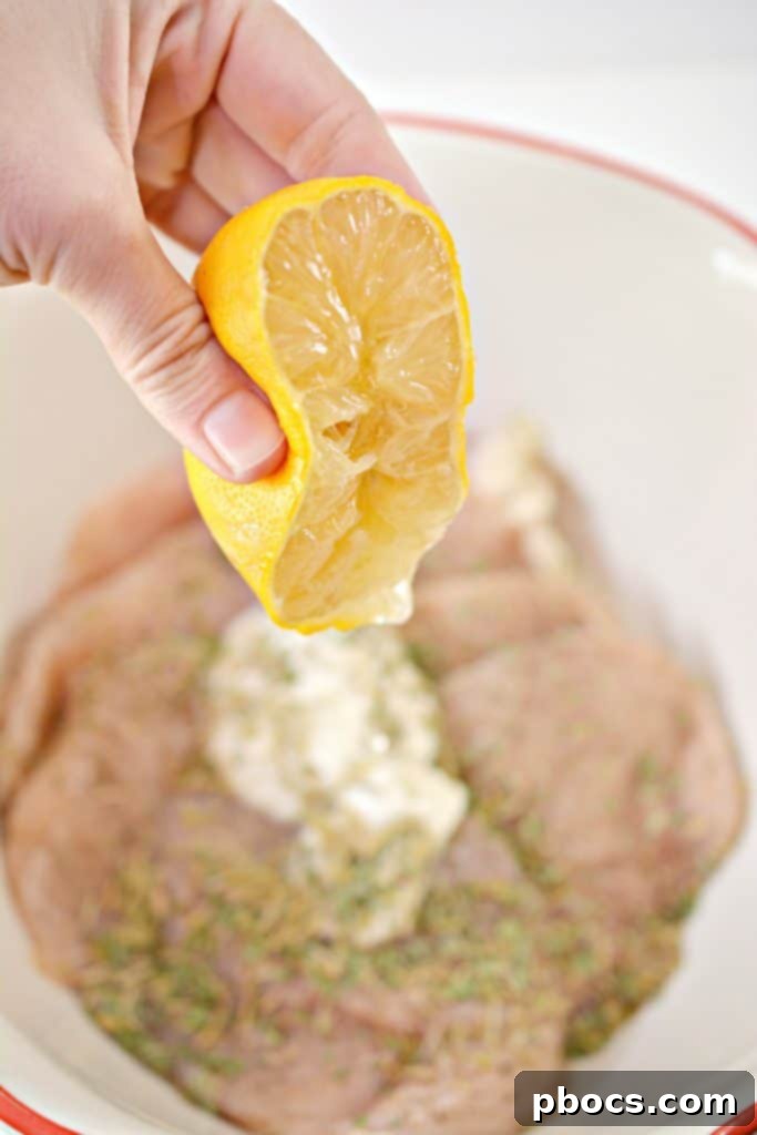 Adding plain Greek yogurt and fresh lemon juice to chicken for the marinade.