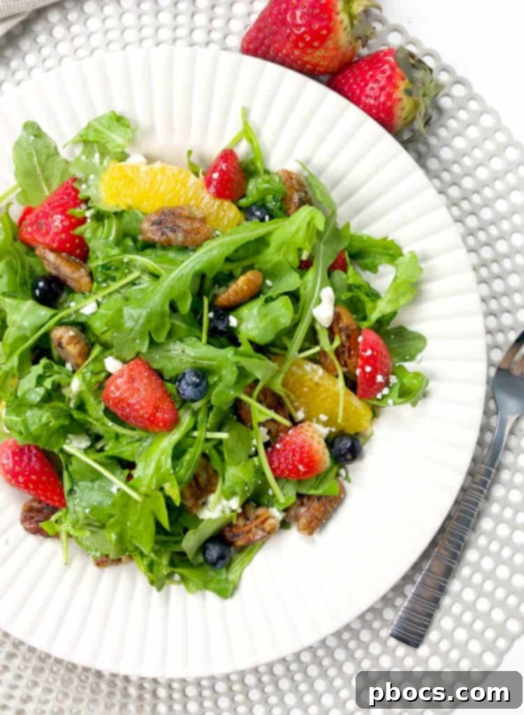Vibrant Arugula Berry Citrus Salad 5 Arugula Berry Citrus Salad on a white plate
