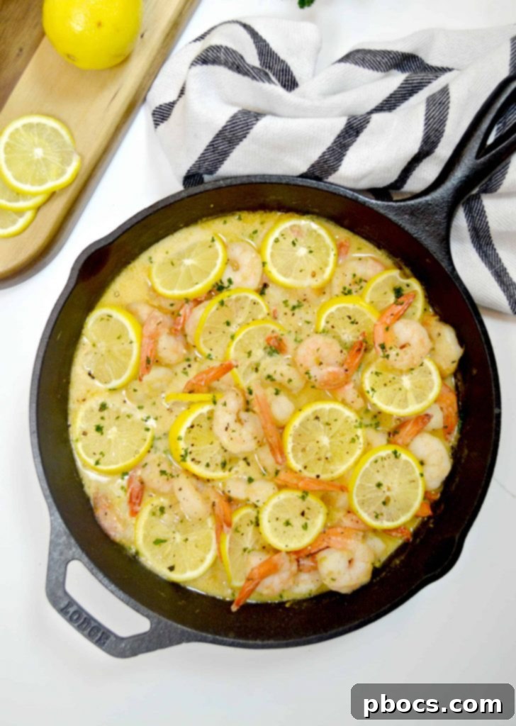 Creamy Lemon Parmesan Shrimp served with fresh lemon slices, a perfect quick and healthy weeknight dinner option.