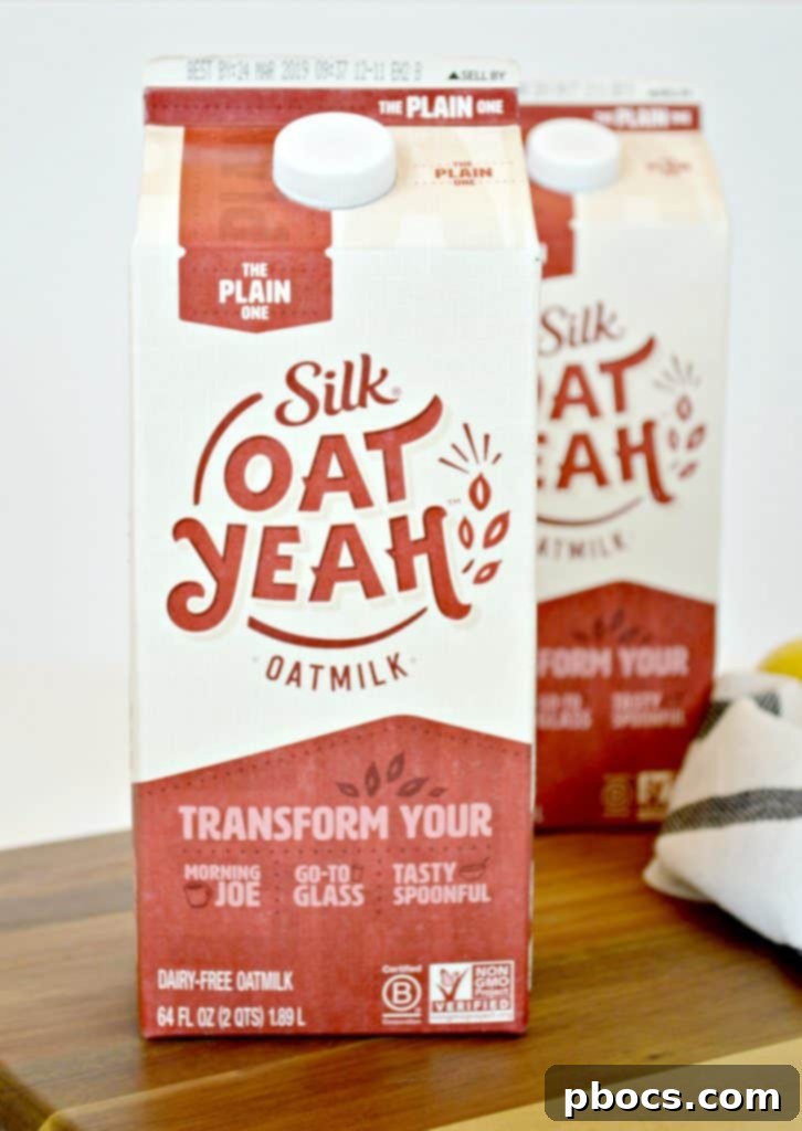 Ingredients for Creamy Lemon Parmesan Shrimp, including a carton of Silk Oat Yeah Original Oatmilk, emphasizing dairy-free cooking.