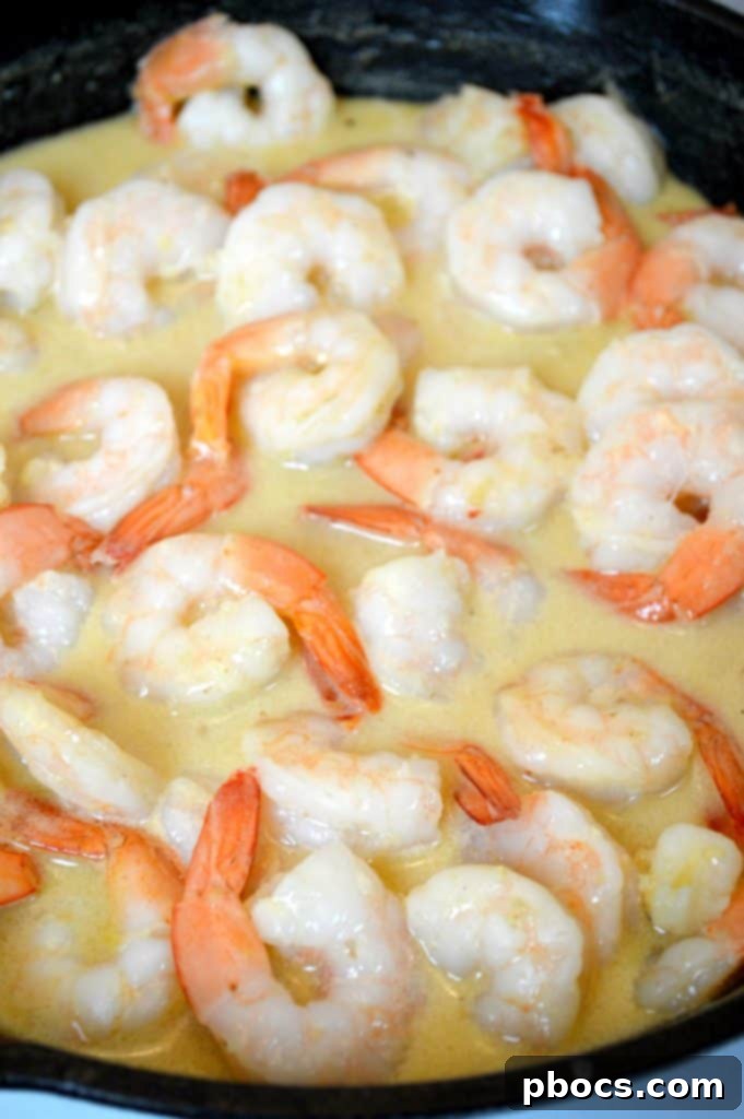 Silk Oat Yeah Original Oatmilk and garlic simmering in a skillet, forming the base of the creamy sauce.