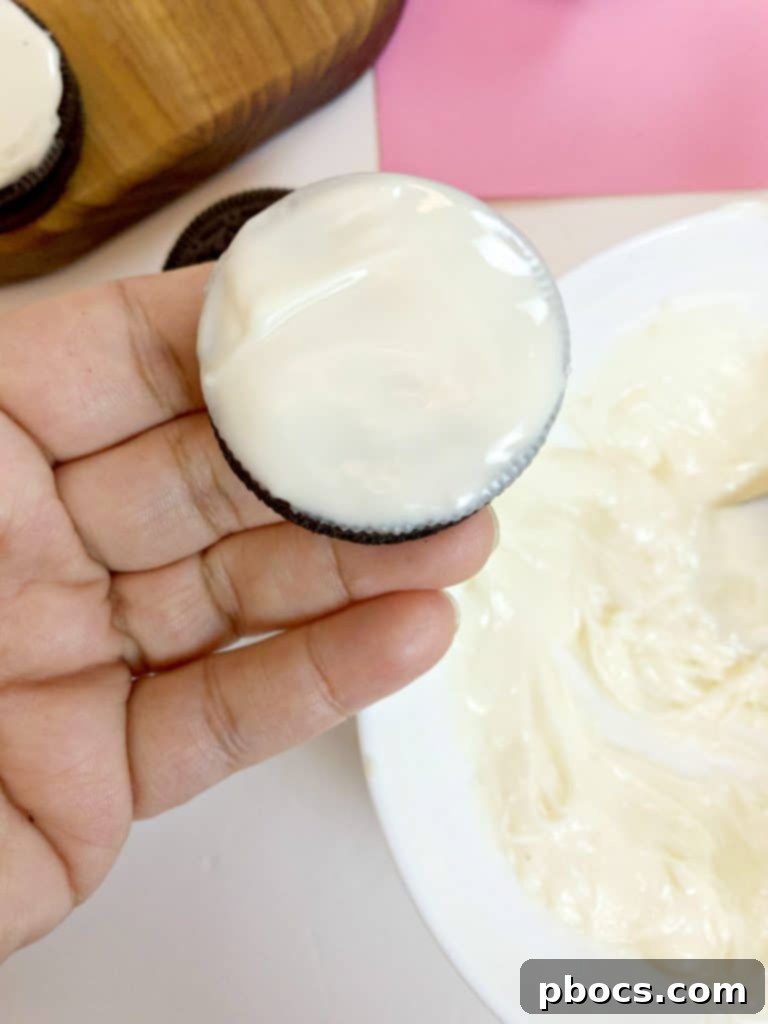 Dipping an OREO cookie into melted chocolate