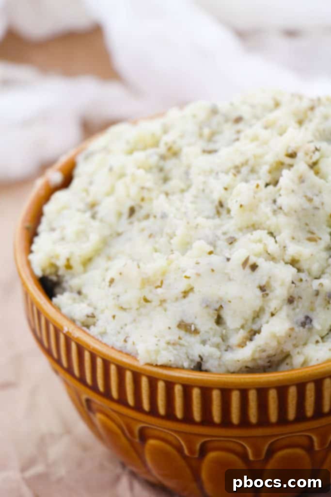 Creamy Keto Cauliflower Mash 4 A bowl of creamy Keto Cauliflower Mashed Potatoes, garnished and ready to enjoy.
