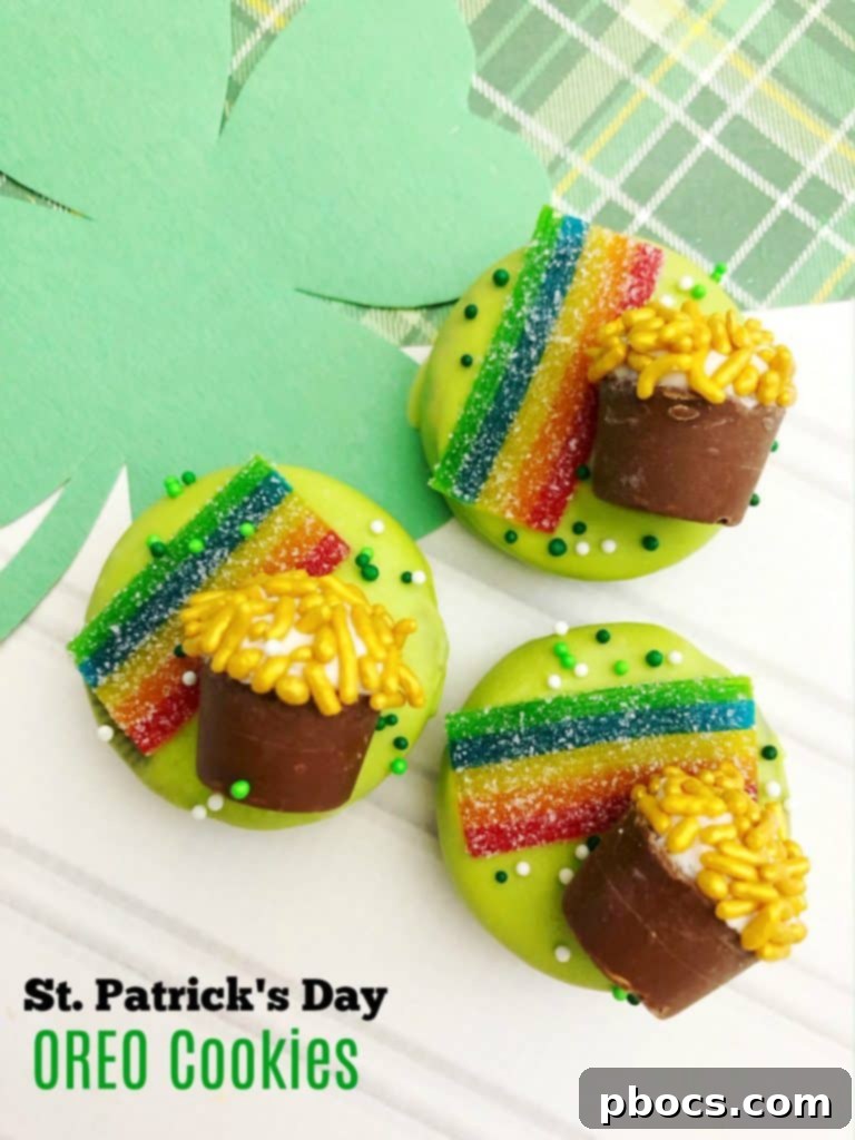 St. Patrick's Day OREO Cookies featuring green-dipped OREOs, a rainbow made from Airhead Extremes, and a Rolo 'pot of gold' adorned with gold sprinkles.