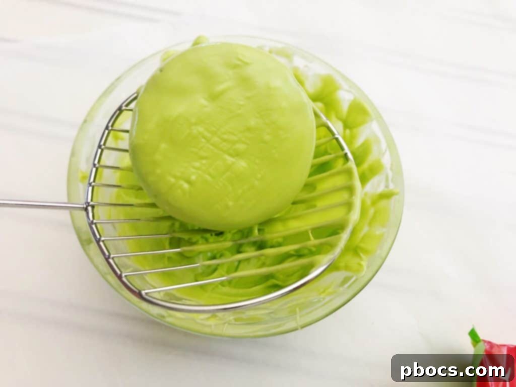 Green candy melts being stirred in a bowl, ready for dipping St. Patrick's Day OREO cookies.