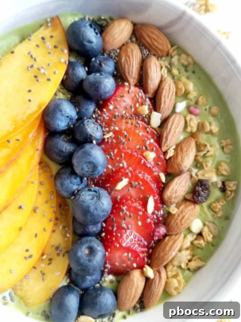 Close-up of a refreshing green smoothie bowl garnished with fresh fruit