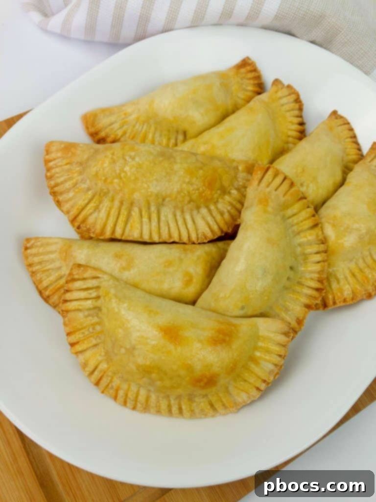 Jalapeno Popper Empanadas - A delicious fusion of creamy cheese, spicy jalapenos, and flaky empanada dough.