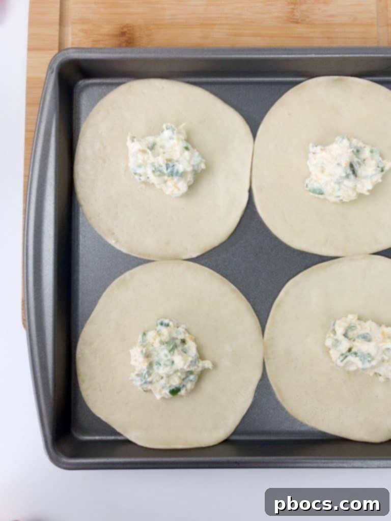 Frozen Empanada Discs laid out on a baking sheet