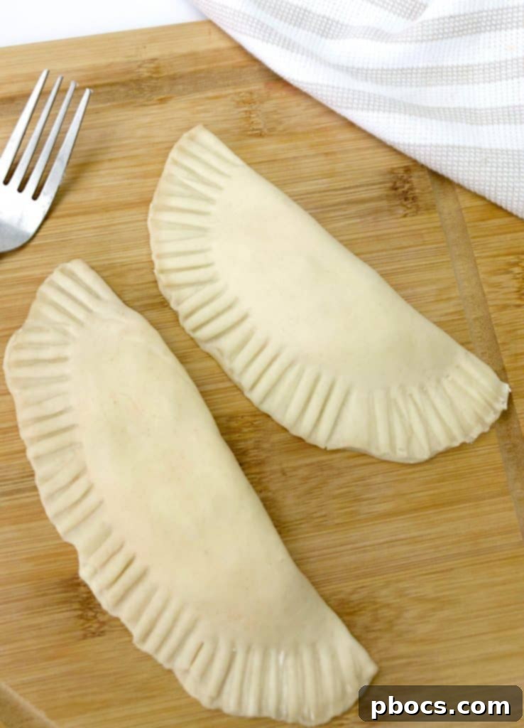 Filling an empanada disc with jalapeno popper mixture