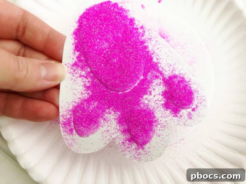 Adorable Paper Plate Bunny Craft 7 Applying Glitter to Bunny Foot Pads