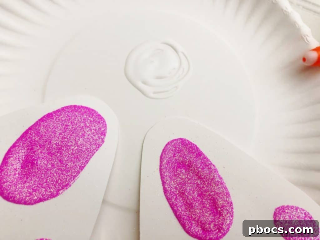Adorable Paper Plate Bunny Craft 8 Gluing Bunny Feet to Paper Plate Body