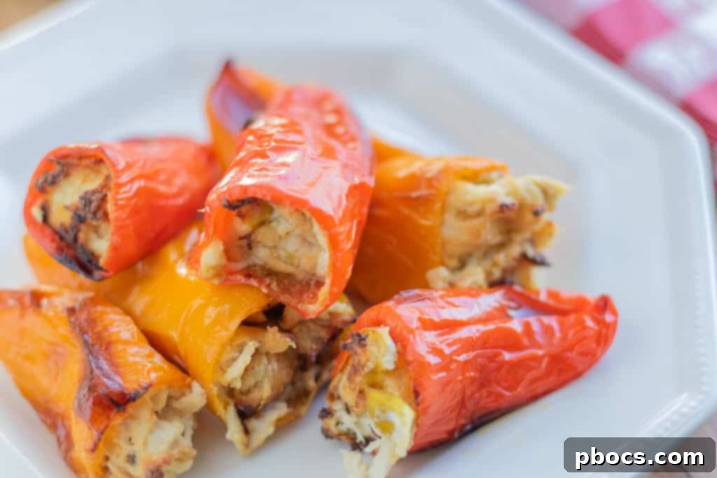 Hand stuffing a sweet bell pepper with creamy chicken mixture