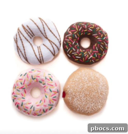 Colorful felt donuts arranged in a charming pastry box, perfect for imaginative play and a unique spring gift basket addition.