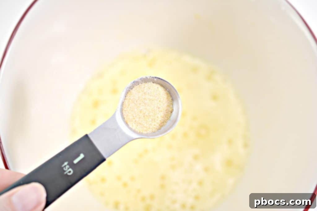 Step 3: Adding garlic powder and basil to beaten eggs
