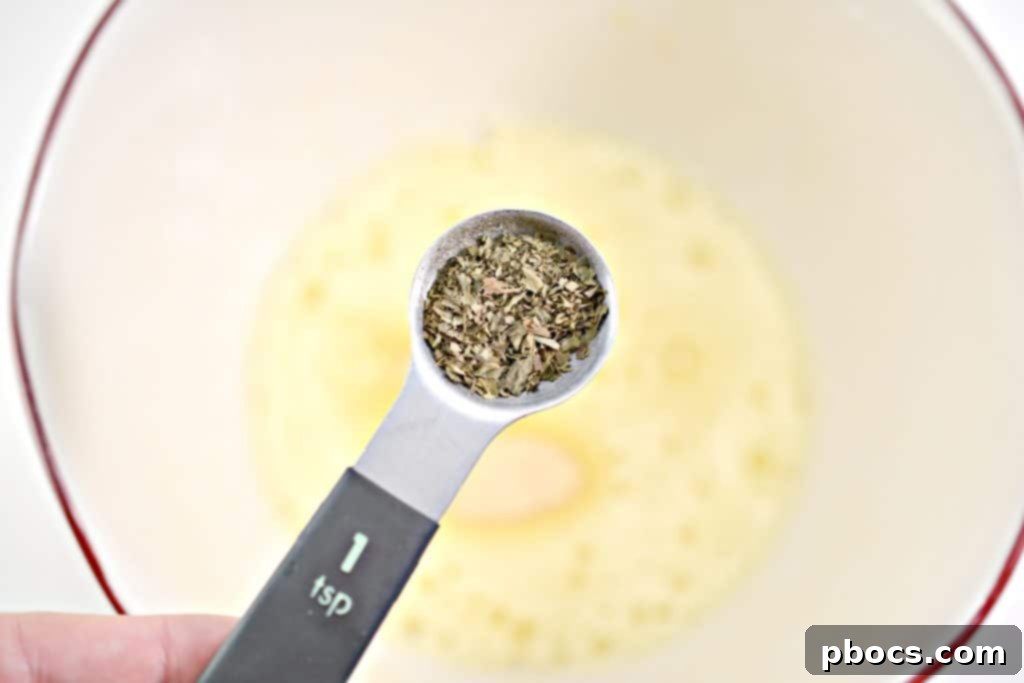 Step 3: Mixing garlic powder and basil into egg mixture