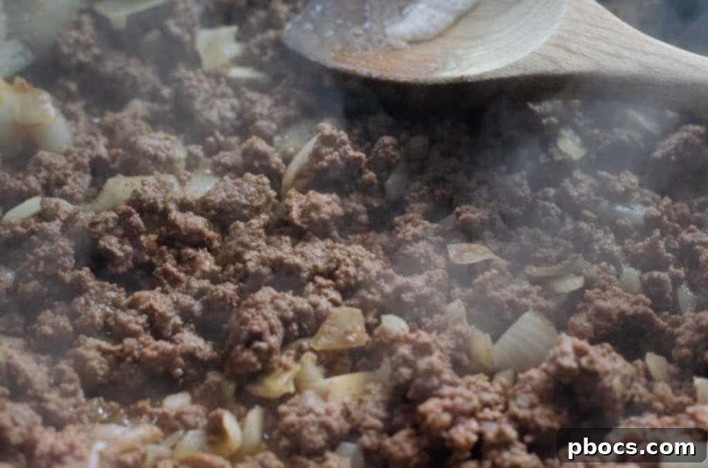 Zesty Low Carb Taco Avocado Boats 6 Adding spices to ground beef for a flavorful taco filling