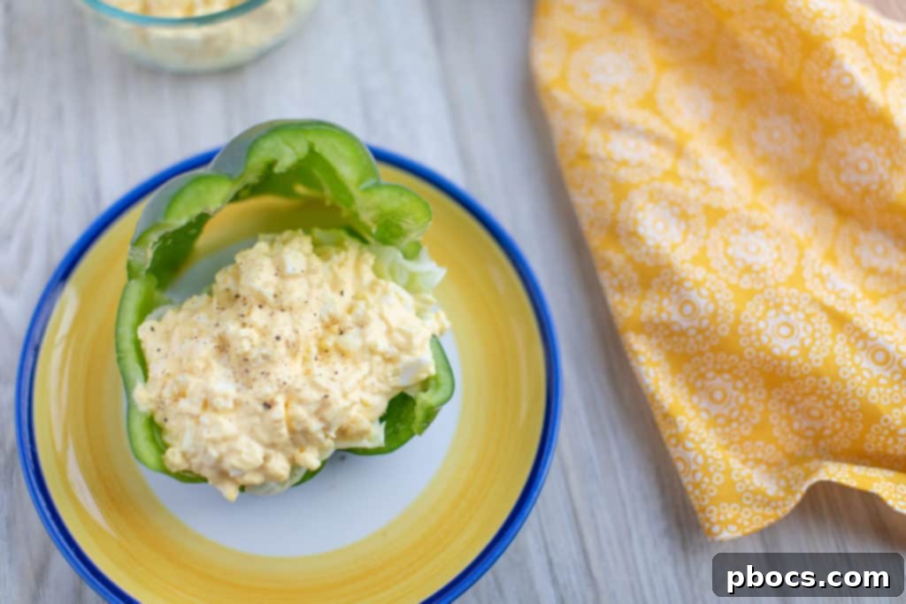 Two halves of a Bell Pepper Keto Egg Salad Sandwich ready to eat