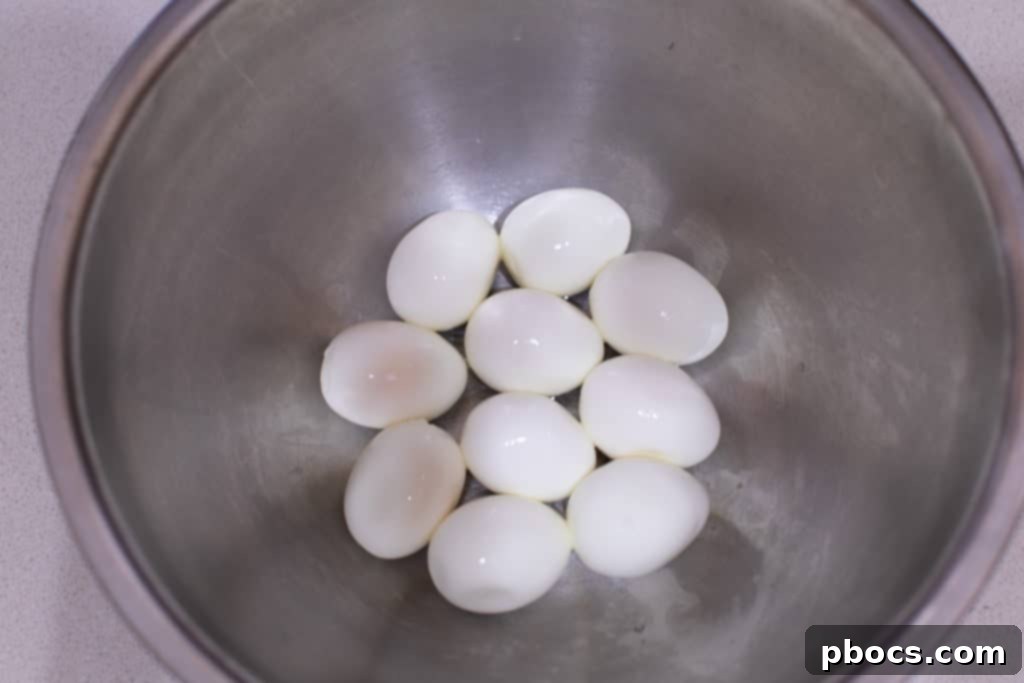 Mashing hard-boiled eggs for egg salad