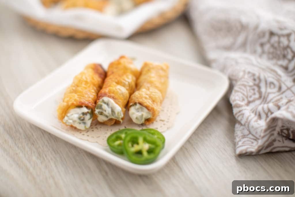 Dynamite Chicken Jalapeño Poppers 4 Ingredients for Crispy Chicken Wrapped Jalapeno Poppers Laying on a Cutting Board