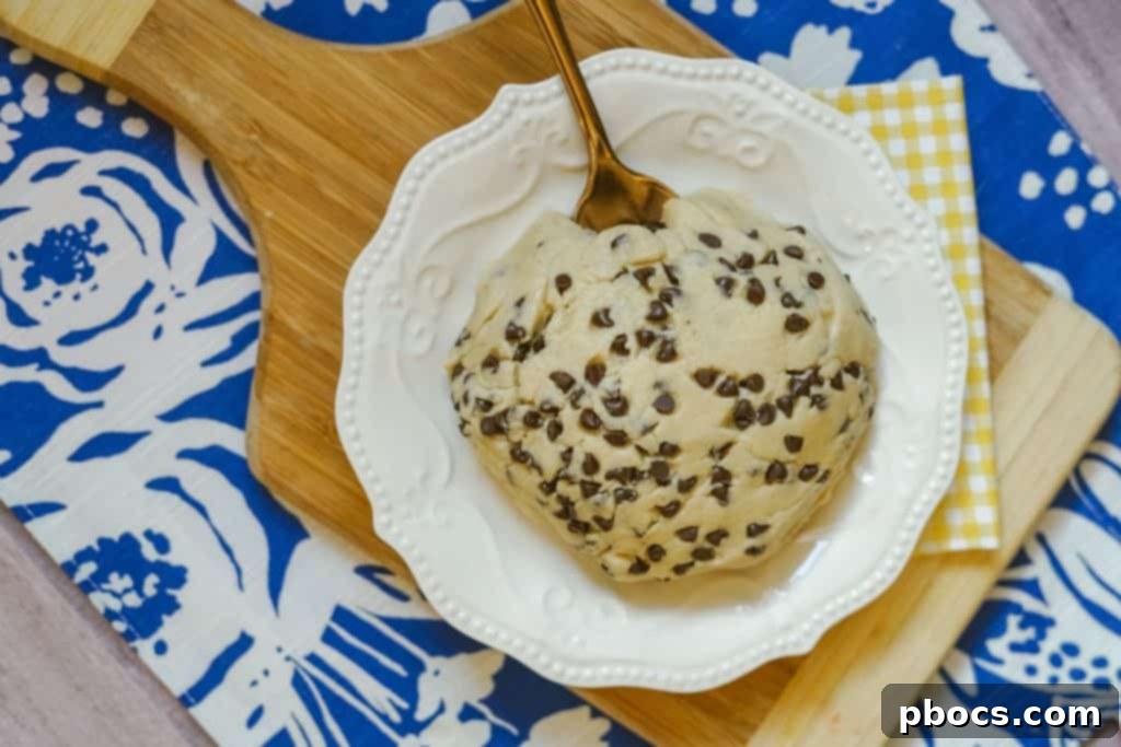 Close-up of Edible Cookie Dough in a bowl with a spoon.
